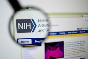 Magnifying glass over NIH logo
