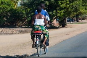 African couple riding bike together