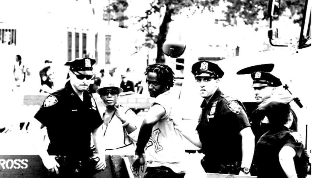 cop arresting black and white