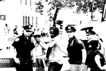 cop arresting black and white